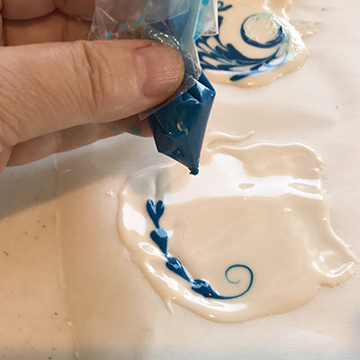 Using a Mini frosting piping tube made from a sandwich bag