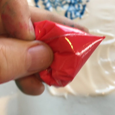 Mini frosting piping tube made from a sandwich bag